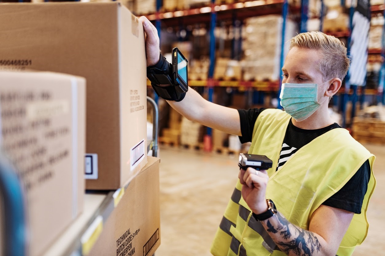a warehouse worker prepares a package for distribution