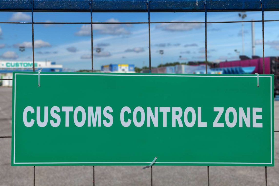 a customs control zone sign on the fence of the logistic customs terminal.